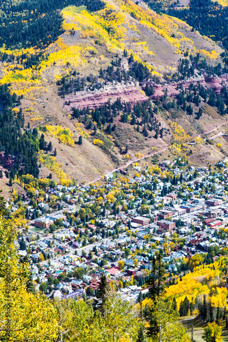 Telluride Colorado - Aerial view of Telluride Colorado in the fall with residential and commercial properties surrounded by apsen trees and red rock mountainsides photo