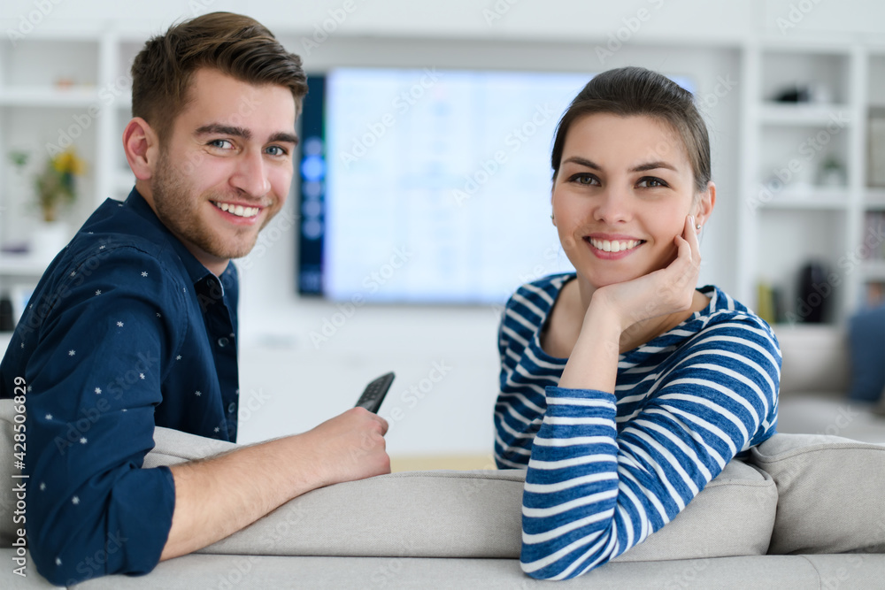 a young married couple enjoys sitting in the large living room a young married couple enjoys sitting in the large living room