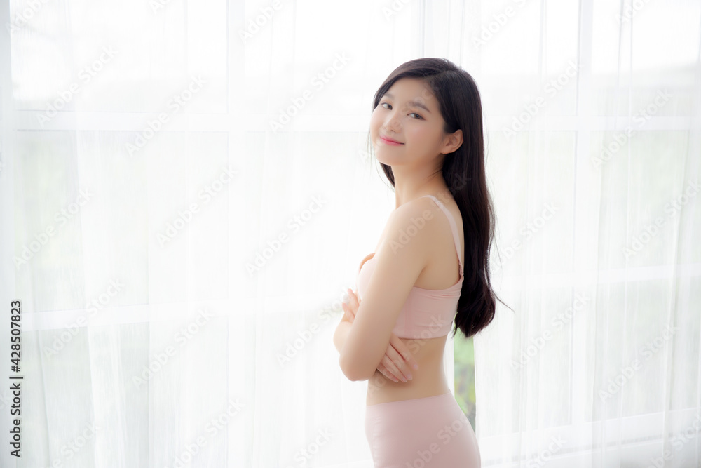 Beautiful portrait young asian woman sexy standing the window and smile while wake up with health, body of girl happy with freshness and cheerful with wellbeing, lifestyle and relax concept. Beautiful portrait young asian woman sexy standing the window and smile while wake up with health, body of girl happy with freshness and cheerful with wellbeing, lifestyle and relax concept.