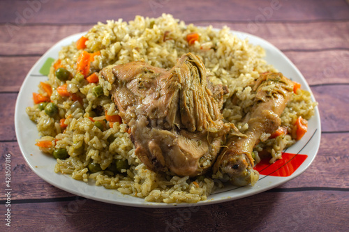 GREEN RICE WITH CHICKEN, WITH CHUNKED CARROT, GREEN PEAN AND PEPPER.