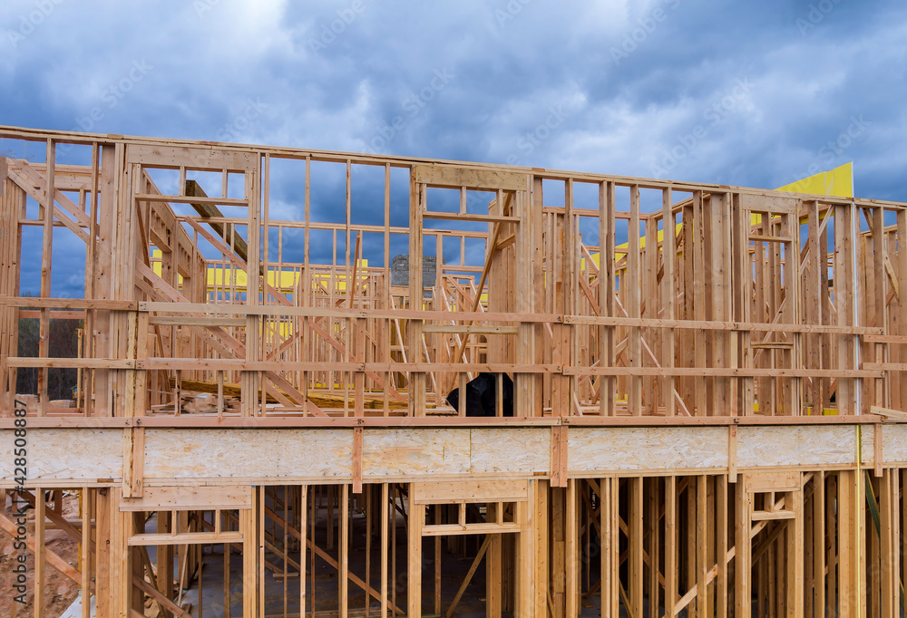 Aerial view of wooden under construction new residential apartment beam framing Aerial view of wooden under construction new residential apartment beam framing