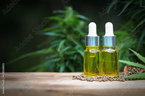 CBD oil hemp products, cannabis extract oil on a wooden table, Medical marijuana.