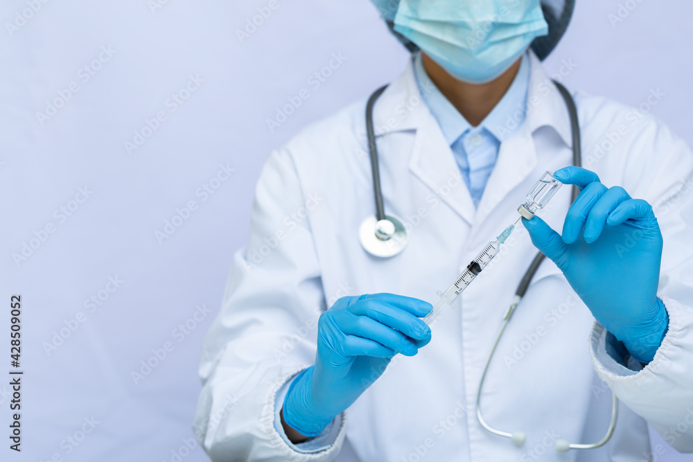 Doctor or scientist in laboratory holding a syringe with liquid vaccines. Concept fight against virus covid-19 corona virus. Doctor or scientist in laboratory holding a syringe with liquid vaccines. Concept fight against virus covid-19 corona virus.