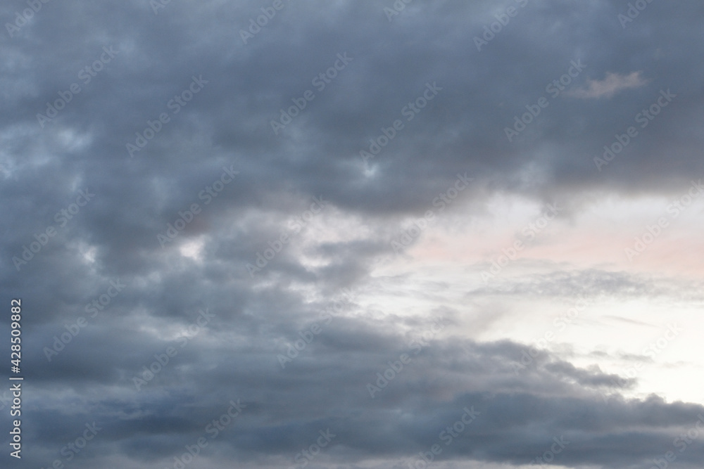 Dark gloomy gray cloudy sky before thunderstorm in summer. Storm heaven, gloomy backdrop.