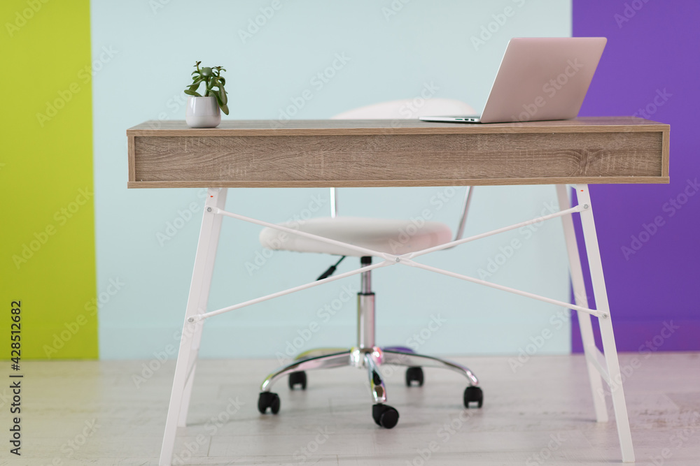 home office concept. chair, laptop, desk and flowers. home office concept. chair, laptop, desk and flowers.