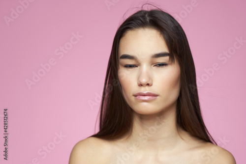 beautiful brunette naked shoulders clear skin pink background cropped view