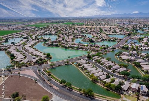 Aerial roofs of the many small ponds near a Avondale town houses in the urban landscape of a small sleeping area Phoenix Arizona US photo