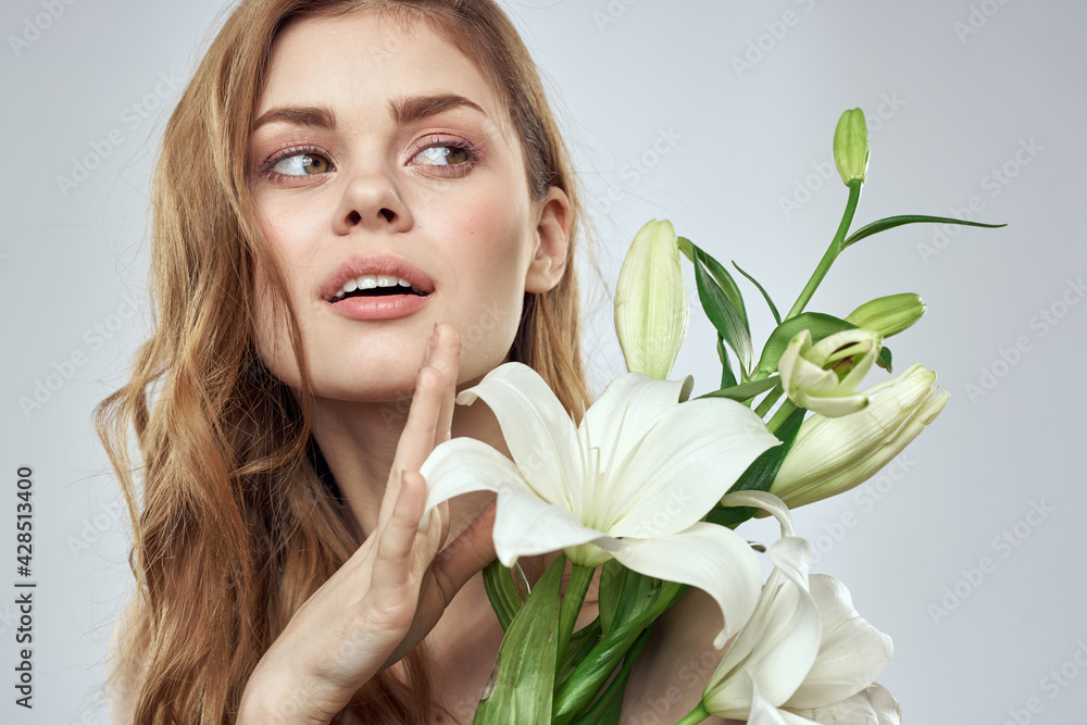 Emotional woman with flowers spring model naked shoulders clear skin Emotional woman with flowers spring model naked shoulders clear skin