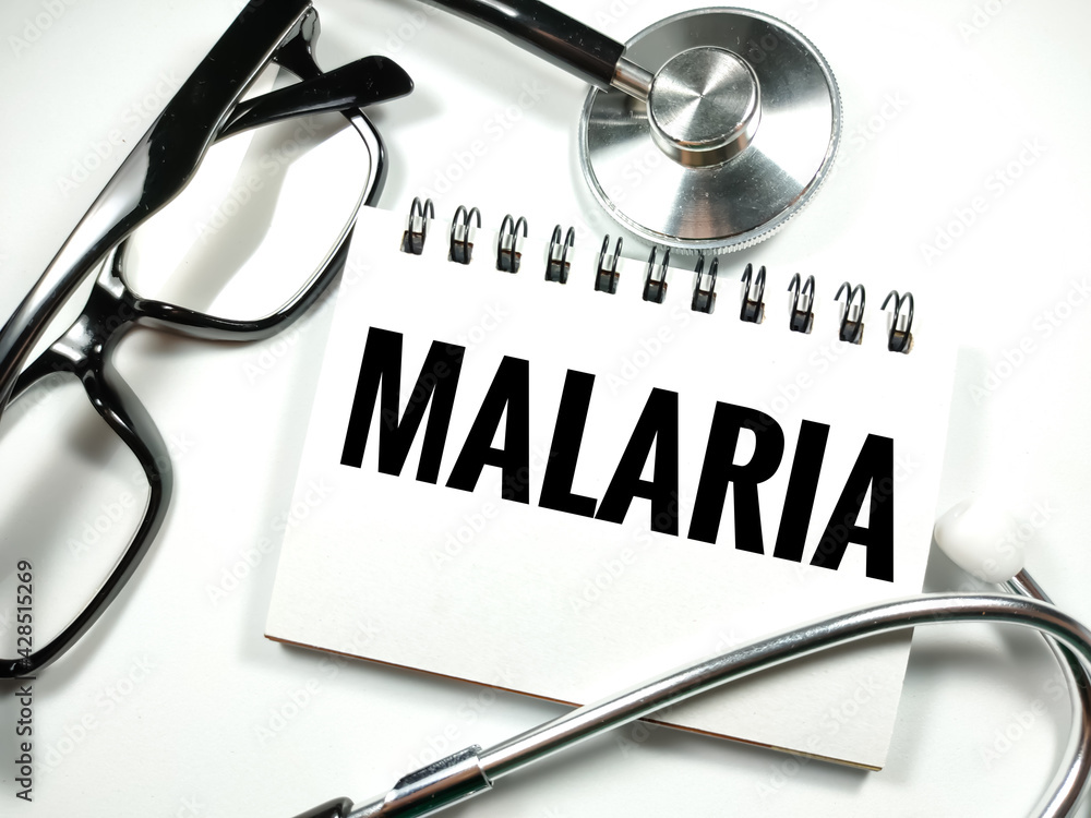 Word MALARIA on notebook with stethoscope and glasses. Medical concept. Word MALARIA on notebook with stethoscope and glasses. Medical concept.