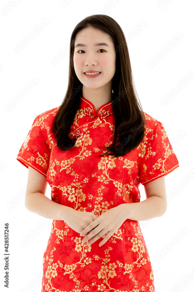 Chinese beautiful woman with long black hairs is standing, smiling, and holding her hands in front of herself. She wearing a red traditional dress that has pattern of gold flower Chinese beautiful woman with long black hairs is standing, smiling, and holding her hands in front of herself. She wearing a red traditional dress that has pattern of gold flower
