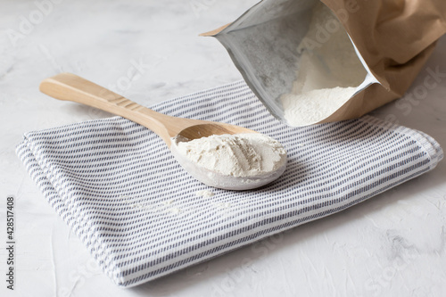 Crumbly xanthan gum in a wooden spoon.