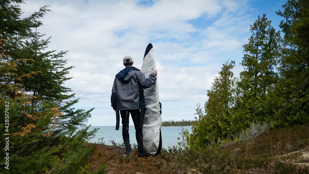 Young man with surfboard. Michigan Surfer. Summer time in Michigan. Young man with surfboard. Michigan Surfer. Summer time in Michigan.