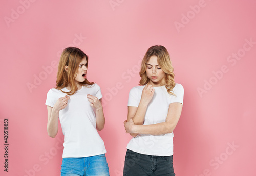 For woman in white t-shirts cropped view of girlfriend pink background © SHOTPRIME STUDIO