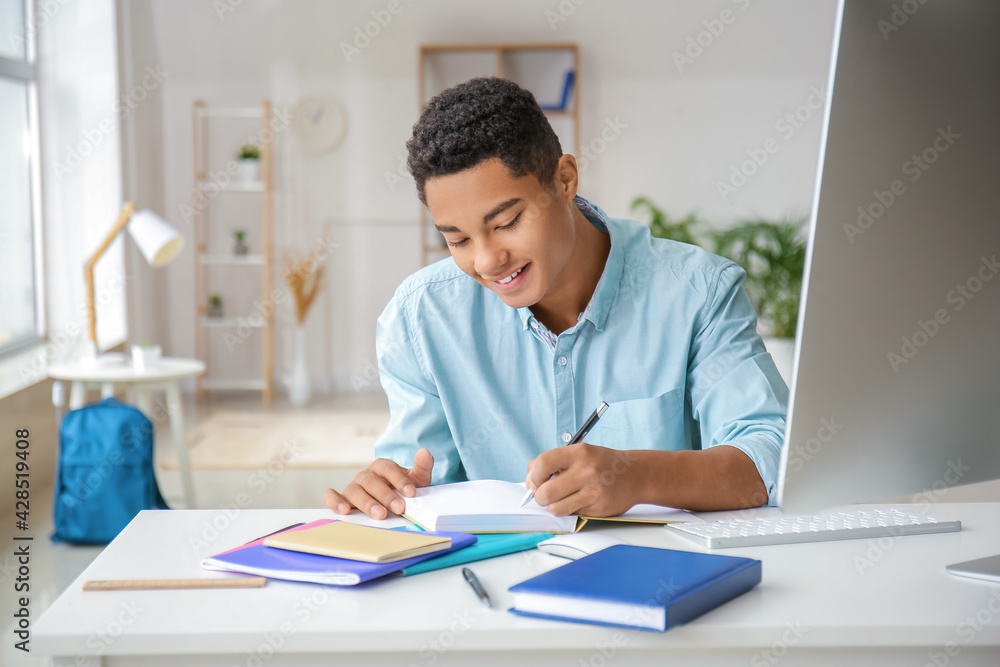 African-American student studying online at home African-American student studying online at home