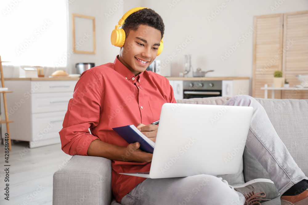 African-American student studying online at home African-American student studying online at home