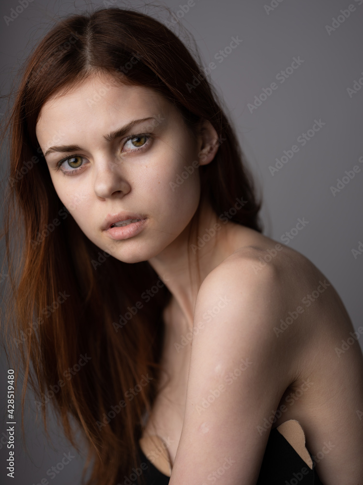 Pretty woman model red hair bared shoulders close-up cropped view Pretty woman model red hair bared shoulders close-up cropped view