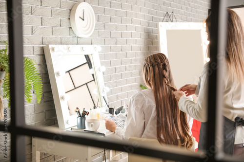 Hairdresser working with cl...