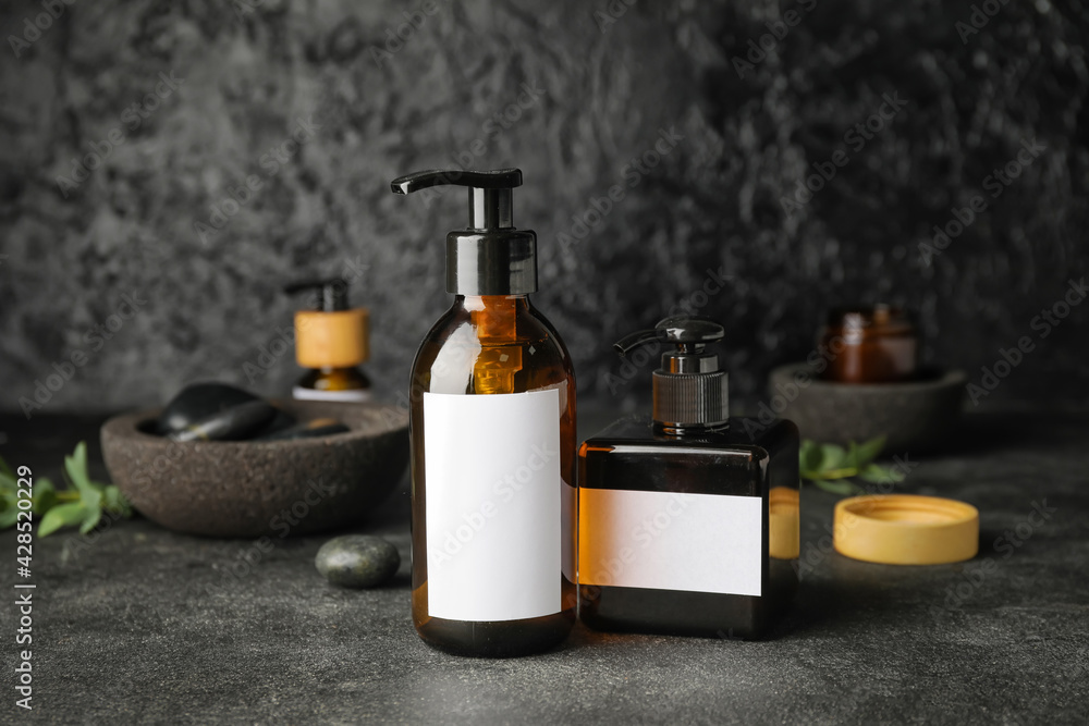 Bottles with natural shampoo on dark background Bottles with natural shampoo on dark background