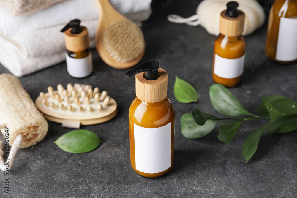 Bottles with natural shampoo on dark background Bottles with natural shampoo on dark background