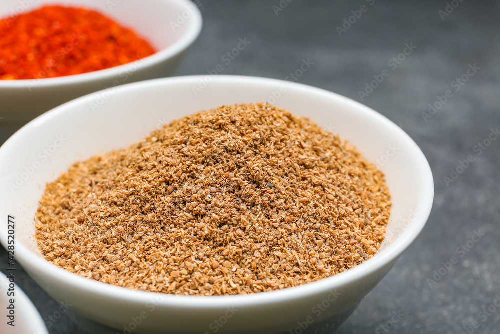 Bowl with pepper powder on dark background, closeup Bowl with pepper powder on dark background, closeup