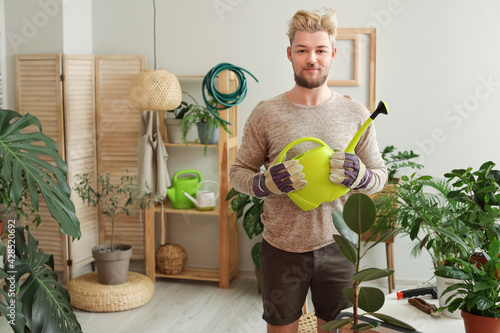 Young man taking care of pl...