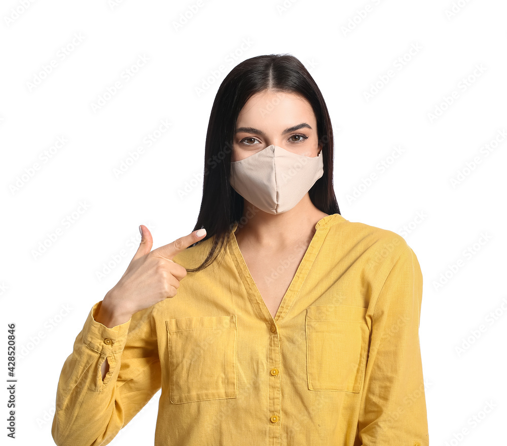 Stylish young woman wearing mask on white background