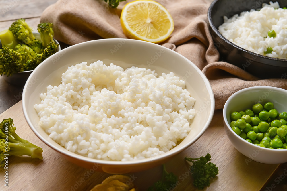 Plate with tasty rice on wooden background Plate with tasty rice on wooden background