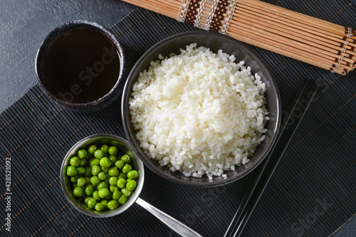 Bowl with tasty rice on dark background