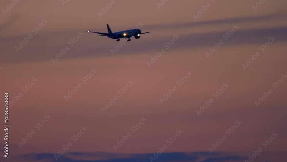 Airplane is landing at sunset Airplane is landing at sunset