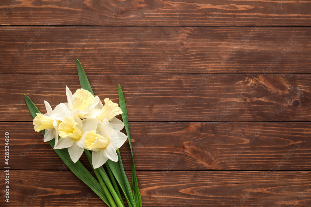 Beautiful daffodils on wooden background Beautiful daffodils on wooden background