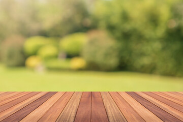 Empty wood table top with abstract blur park garden background