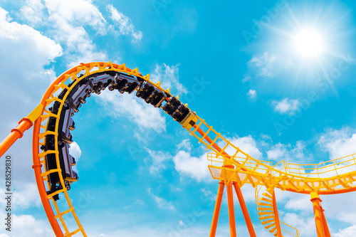 Canvas Print roller coaster high in the summer sky at theme park most excited fun and joyful