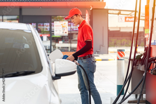 Obraz na plátne Gas station male man worker staff happy service working refill car gasoline fuel