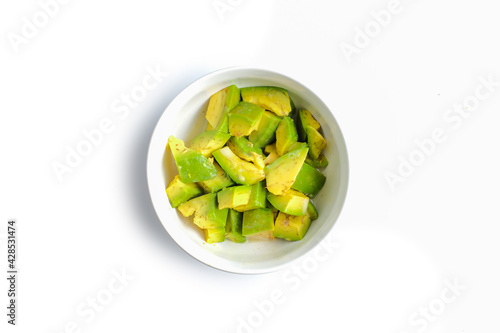 Fresh sliced avocado in white bowl
