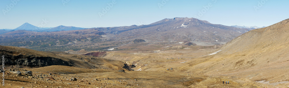 Panorama view of the Opasny canyon near the Mutnovsky volcano. The depth of the canyon surprises with its scale and incredible views of the volcanoes. Kamchatka Peninsula, Russia.