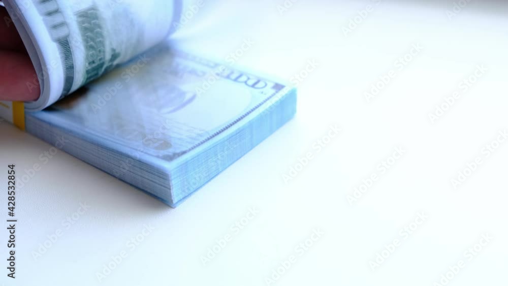 Stack of hundred dollar bills on a white background. Stack of hundred dollar bills on a white background.