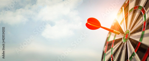 Red dart target with arrows ,Image for target business, marketing solution concept.of dartboard with sky background.