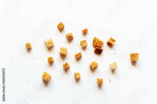 scattered crumbs of roasted white bread on a white background