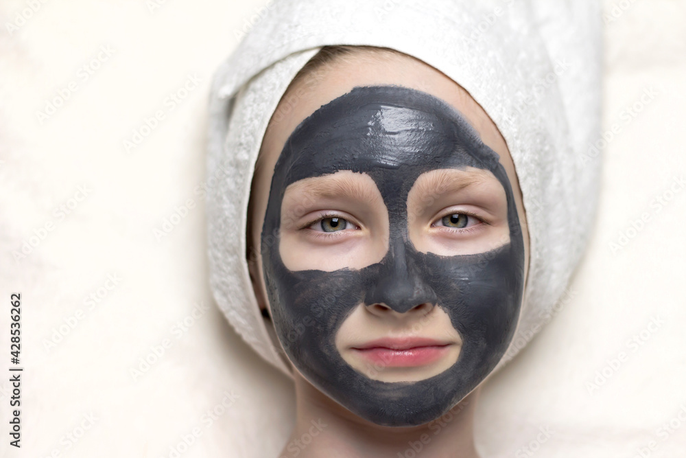 Girl with a cosmetic mask on her face. Girl with a cosmetic mask on her face.