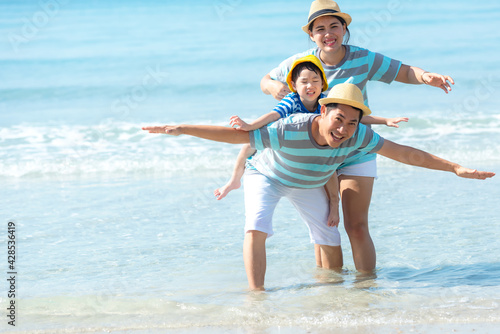 Asia happy family have fun on the beach watching the landing planes. Traveling on an airplane for leisure and destination. Family tourism travel in summer and holiday