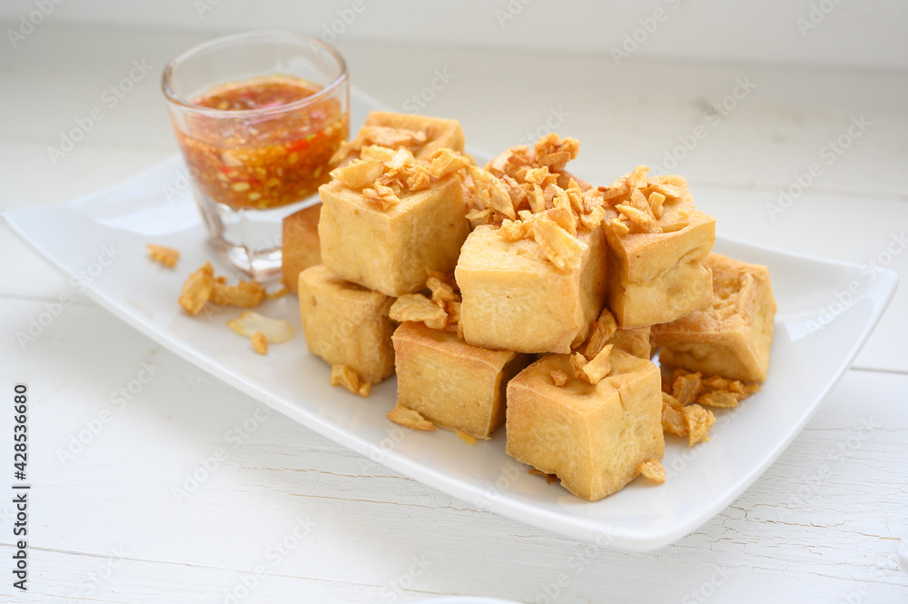 Deep fried tofu is cut into square balls on plate Deep fried tofu is cut into square balls on plate