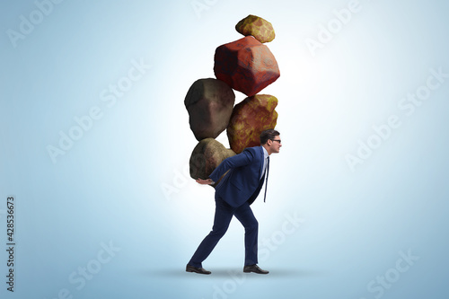 Φωτογραφία Businessman under burden in business concept