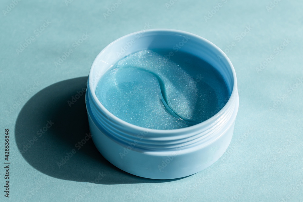 cosmetic hydrogel patches for moisturizing and nourishing the skin under the eyes on bue background.Skin care, wellness and spa concept, mockup with copy space. cosmetic hydrogel patches for moisturizing and nourishing the skin under the eyes on bue background.Skin care, wellness and spa concept, mockup with copy space.