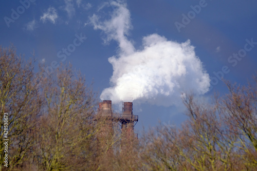 Steam and smoke emitting from steel making plant stack.