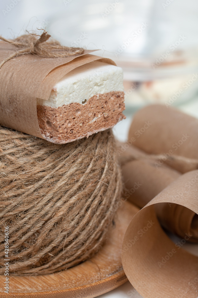 Portion marshmallow with cocoa and cranberries. Wrapped in paper and tied with string. Two-layer zephyr. Portion marshmallow with cocoa and cranberries. Wrapped in paper and tied with string. Two-layer zephyr.