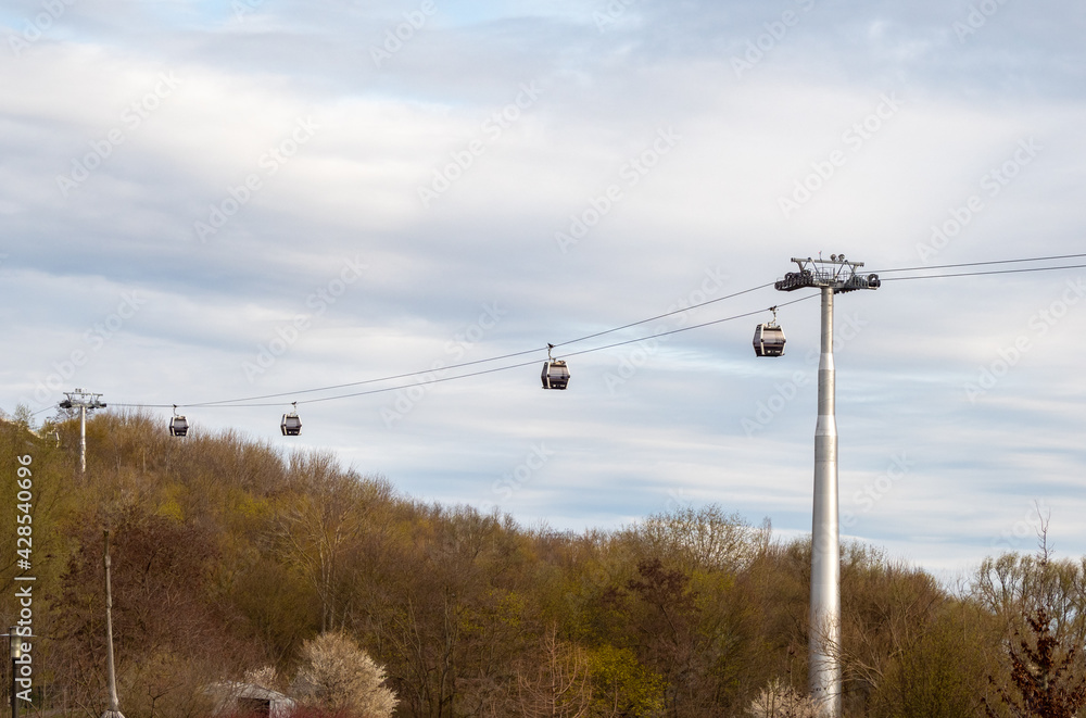 cable car cabins moving over the forest