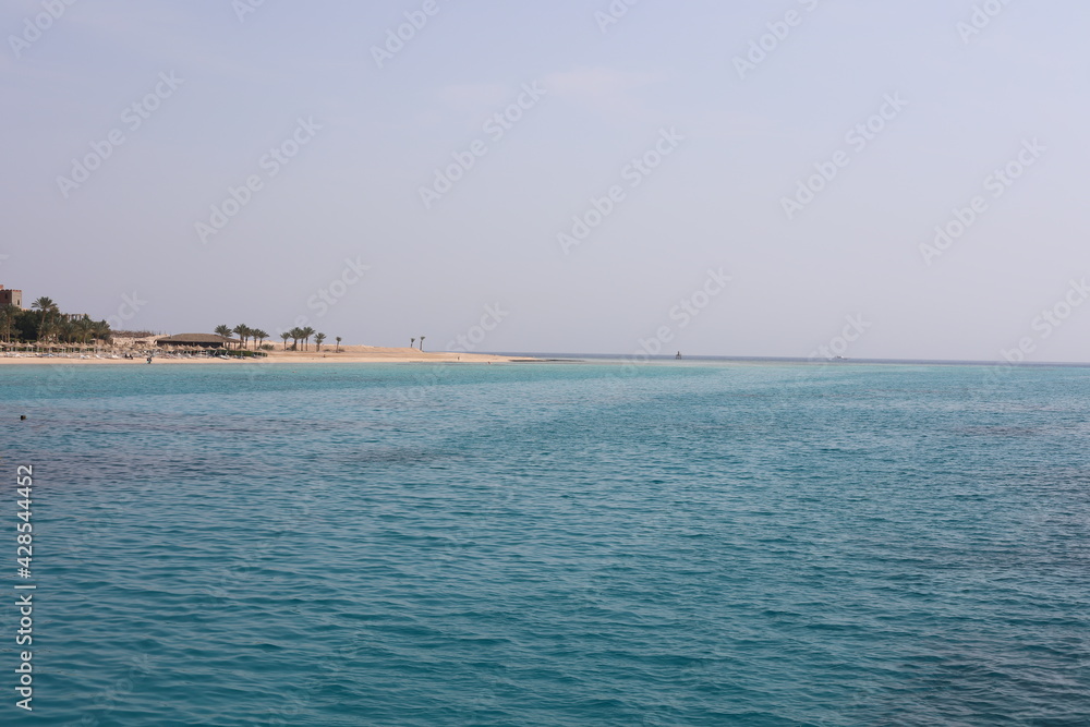 Clear waves on the beach. Beauty of beach in the morning. Blue water ripples. Wonderful swim in clean turquoise sea water. Scenic backdrop of beautiful transparent water of the Red Sea with sun shine