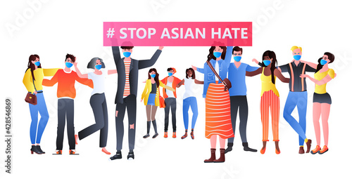 stop asian hate activists in masks protesting against racism support people during coronavirus pandemic
