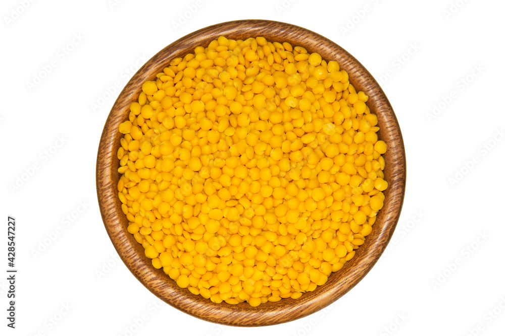 Yellow lentils in wooden bowl. Isolated on white background Yellow lentils in wooden bowl. Isolated on white background