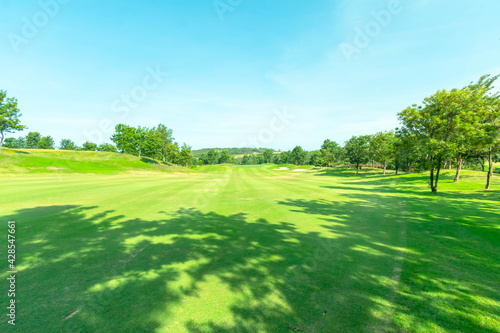 Fototapeta Naklejka Na Ścianę i Meble -  View of Golf Course with beautiful green field. Golf course with a rich green turf beautiful scenery.